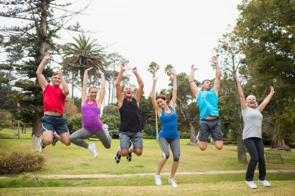 Happy athletic jumping together on a sunny day